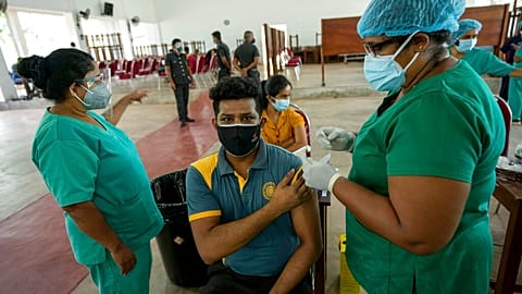 A Sri Lankan university student receives his coronavirus vaccine at the Sri Jayawardenapura university in Colombo, Sri Lanka, Monday, Oct. 11, 2021. 