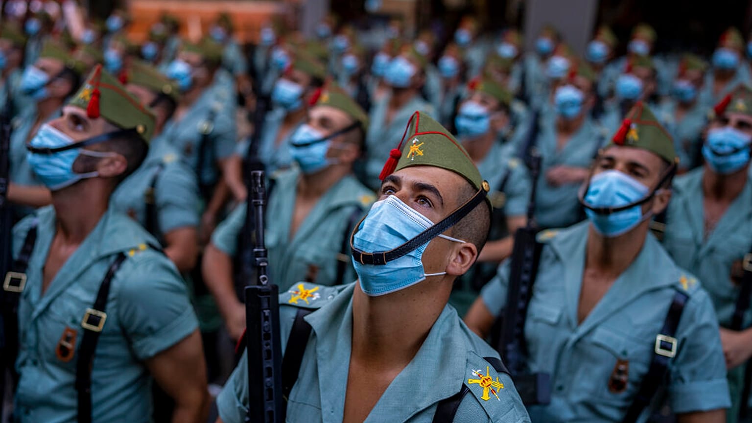 Members of La Legion, an elite unit of the Spanish Army, wait for the start of the military parade