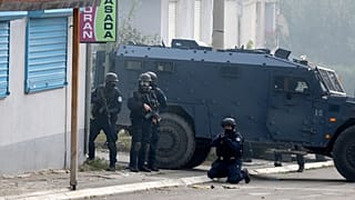 Kosovo police officers guard a street in the northern Serb-dominated part of Mitrovica.