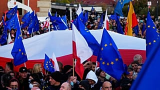 People wave EU and Polish flags in support of Poland's EU membership during a demonstration, in Warsaw, Poland, Sunday, October 10, 2021.