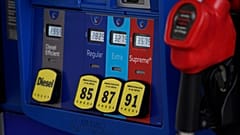 In this May 9, 2021, file photo prices are illuminated above the levers for the different grades of gasoline available at a pump at an Exxon station.