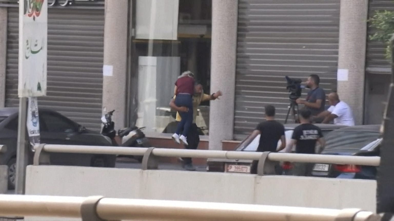 Man carrying a wounded woman