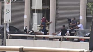 Man carrying a wounded woman