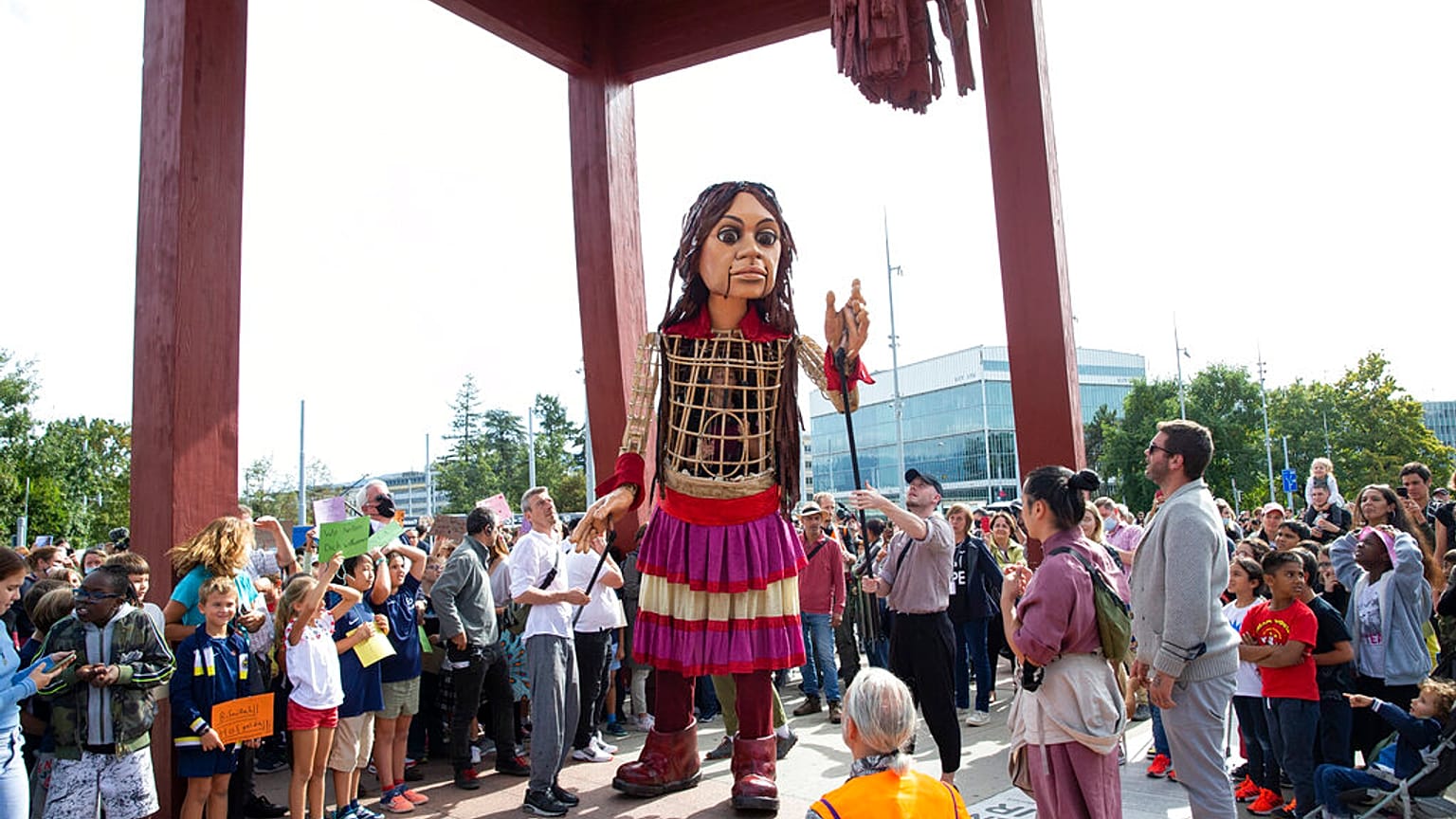 Giant puppet Amal, created by Handspring Puppet Company symbolizing a young refugee girl, walks in support of refugees