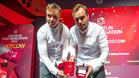 Twins, Garden chefs Ivan and Sergey Berezutsky, who received two Michelin stars, show their award as they take part in the award ceremony, which took place in Moscow.