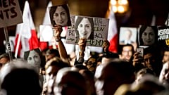 Protesters hold photos of murdered journalist Daphne Caruana Galizia at a demonstration in Valletta on November 19, 2019