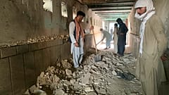 People inspect the inside of a mosque following a suicide bombers attack in the city of Kandahar, southwest Afghanistan, Friday, Oct. 15, 2021.