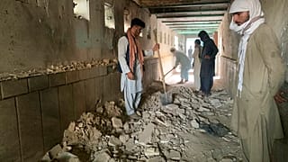 People inspect the inside of a mosque following a suicide bombers attack in the city of Kandahar, southwest Afghanistan, Friday, Oct. 15, 2021.