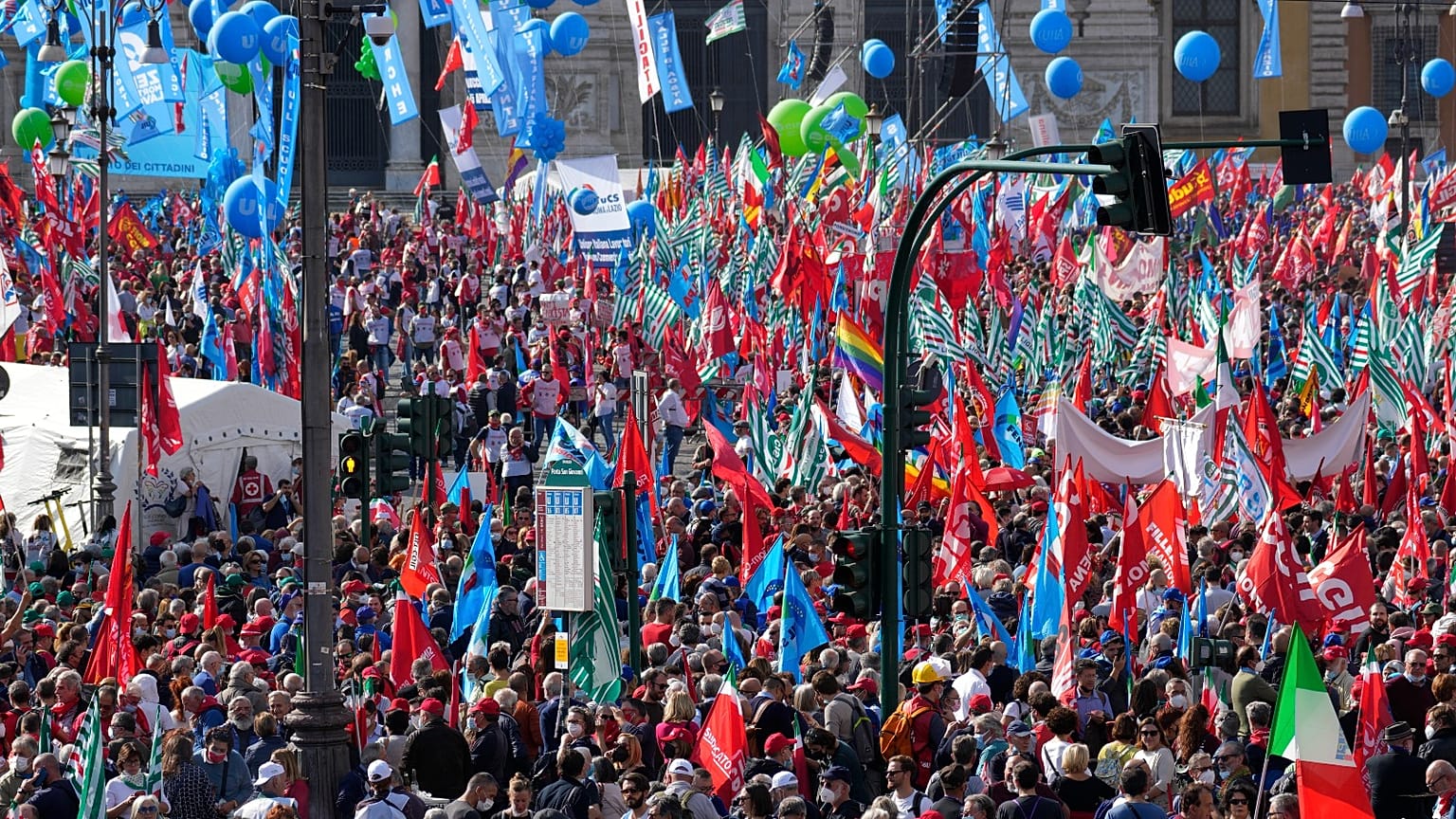 Demonstrators take part in a march organized by Italy's main labour unions, in Rome's St. John Lateran square, Saturday, Oct. 16, 2021