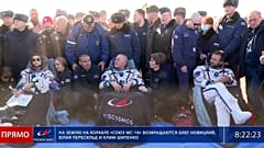 Russian space agency cosmonaut Oleg Novitskiy, centre, actress Yulia Peresild, left, and film director Klim Shipenko sit in chairs shortly after landing in Kazakhstan.