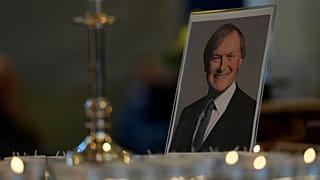 Candles are lit next to a portrait of British Lawmaker David Amess during a vigil for him at St Michaels Church, in Leigh-on-Sea, England Sunday, Oct. 17, 2021.