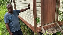 Botu built this house after his childhood home was washed away, forcing him to build about 50 metres inland.  Since then he has had to move to a third home on higher ground.