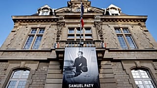 A photo of French teacher Samuel Paty is displayed on the city hall in Conflans-Sainte-Honorine.