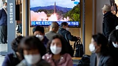 A TV screen showing a news program reporting about North Korea's missile launch with file footage is seen at a train station in Seoul, South Korea, Tuesday, Oct. 19, 2021.