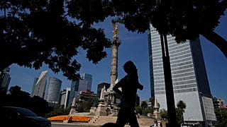 Un hombre trota frente al monumento del Ángel de la Independencia, 18/10/2021, Ciudad de México, México