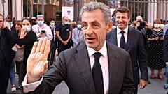 French former President Nicolas Sarkozy waves as he leaves after a tribute ceremony for Samuel Paty in Nice, 15 October 2021