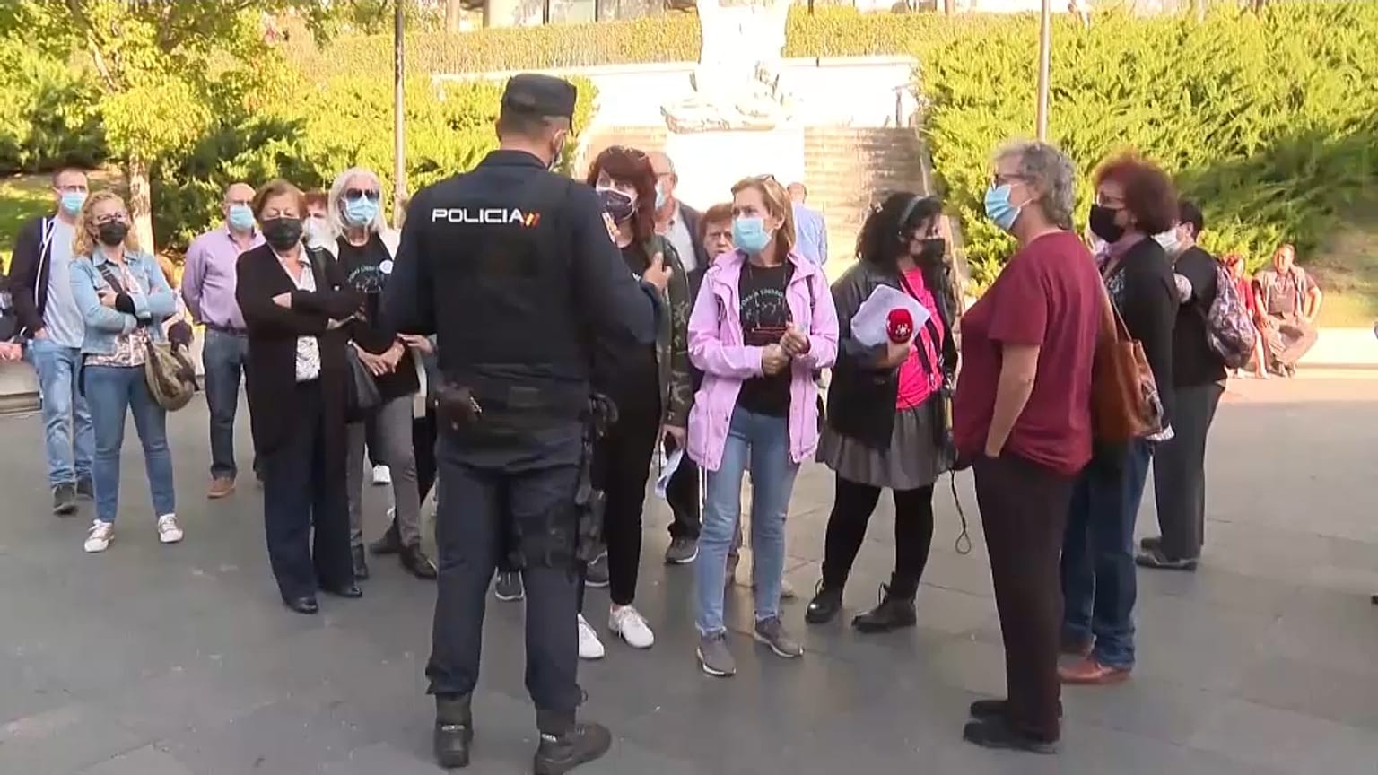 Un agente de policía habla con algunos de los miembros de la Plataforma Seguimos Viviendo