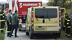 Austrian firemen inspect the van where two migrants were discovered dead during a control near the Austrian-Hungarian border
