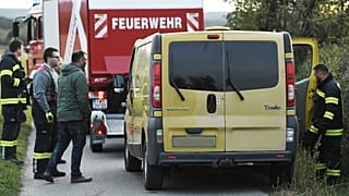 Austrian firemen inspect the van where two migrants were discovered dead during a control near the Austrian-Hungarian border
