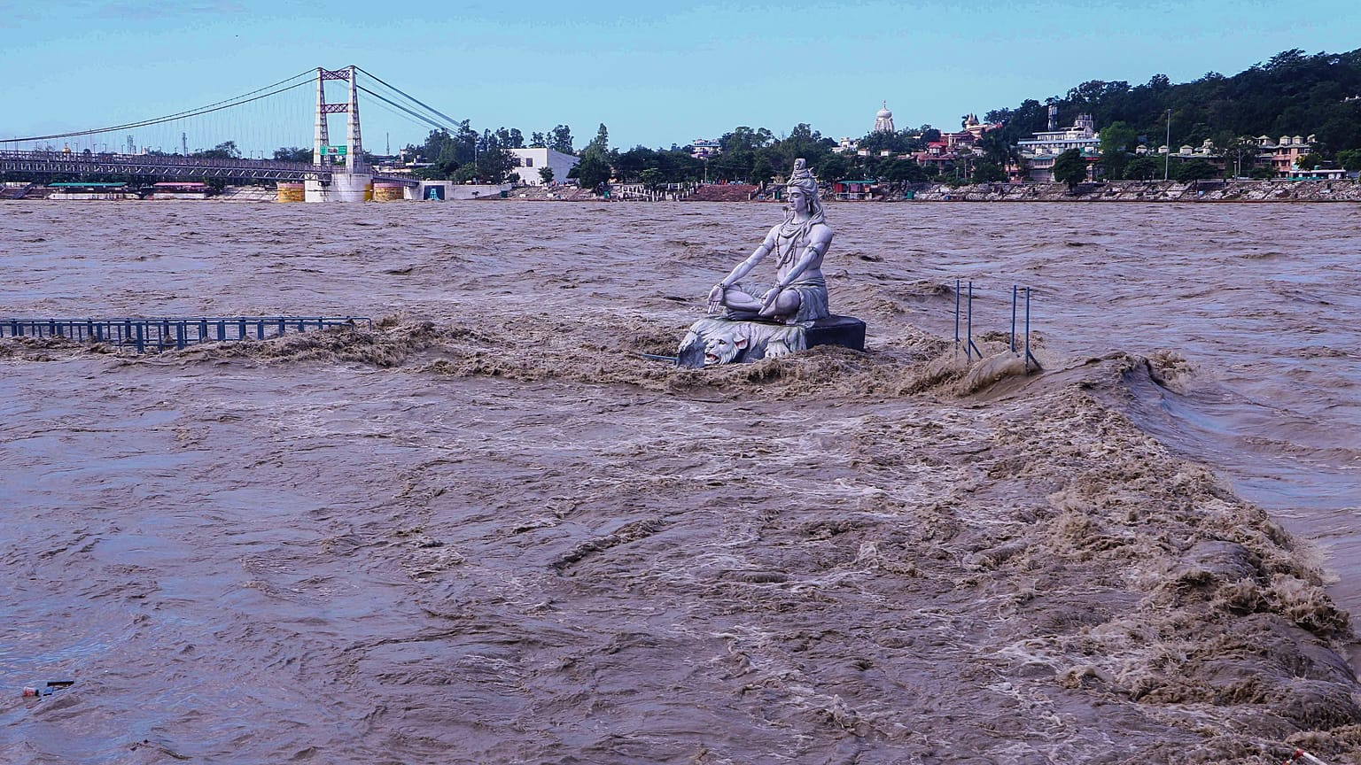 A statue of Hindu god Lord Shiva is pictured amid the risen water levels of River Ganga