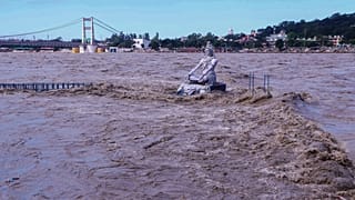 A statue of Hindu god Lord Shiva is pictured amid the risen water levels of River Ganga