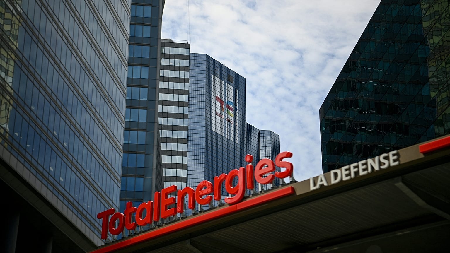 This photograph taken on May 28, 2021 shows the new TotalEnergies logo during its unveling ceremony, at a charging station in La Defense on the outskirts of Paris.