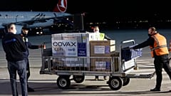 Airport personal unload the first batch of the AstraZeneca vaccines sent from the Covax facility, at Adem Jashari airport Pristina, Kosovo, March 28, 2021.