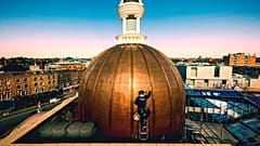 A person works at the newly restored dome of the KOKO Theater, in Camden, London