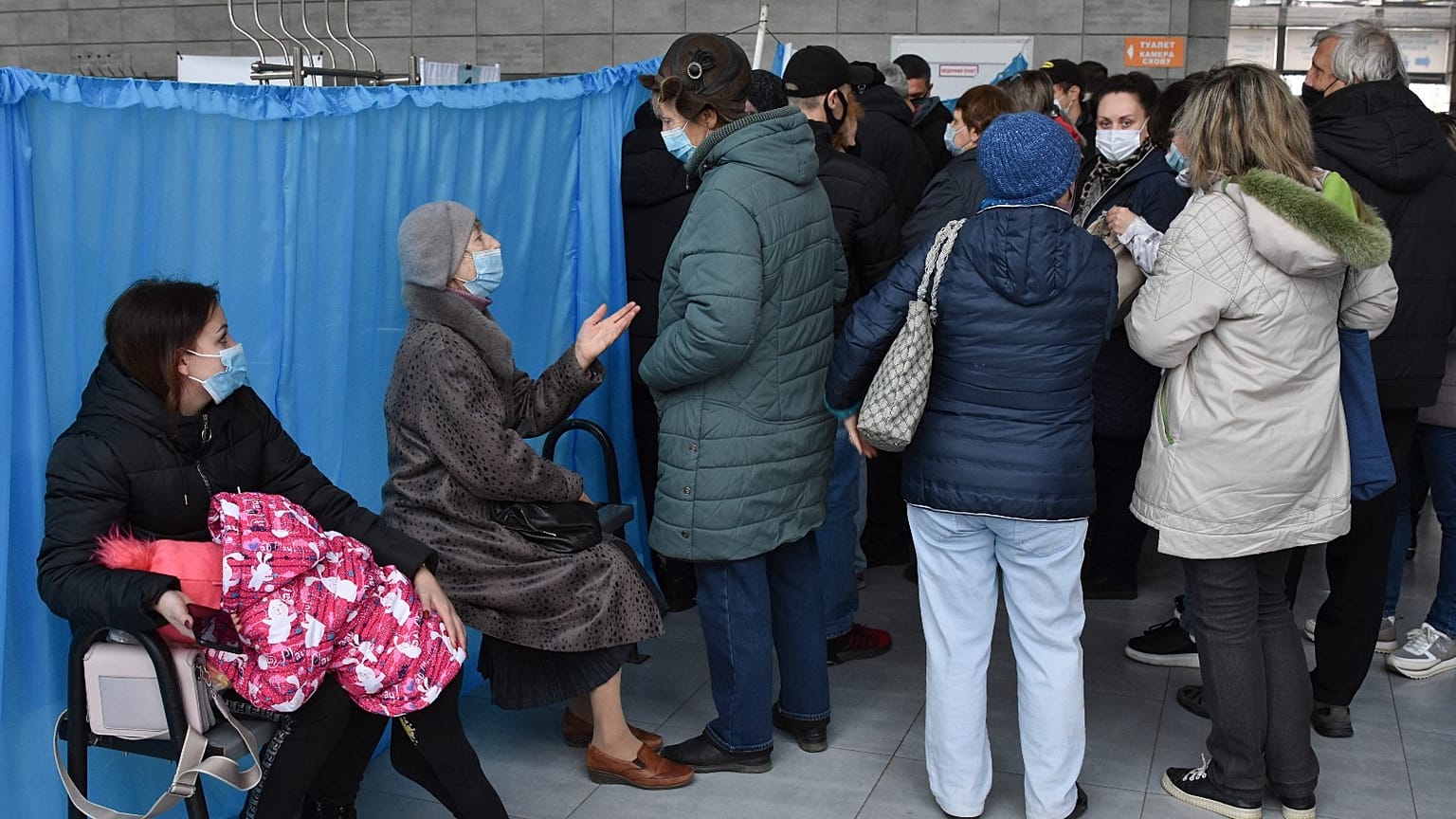 People wait for their turn at a vaccination center in Kramatorsk, Ukraine, Friday, Oct. 22, 2021.