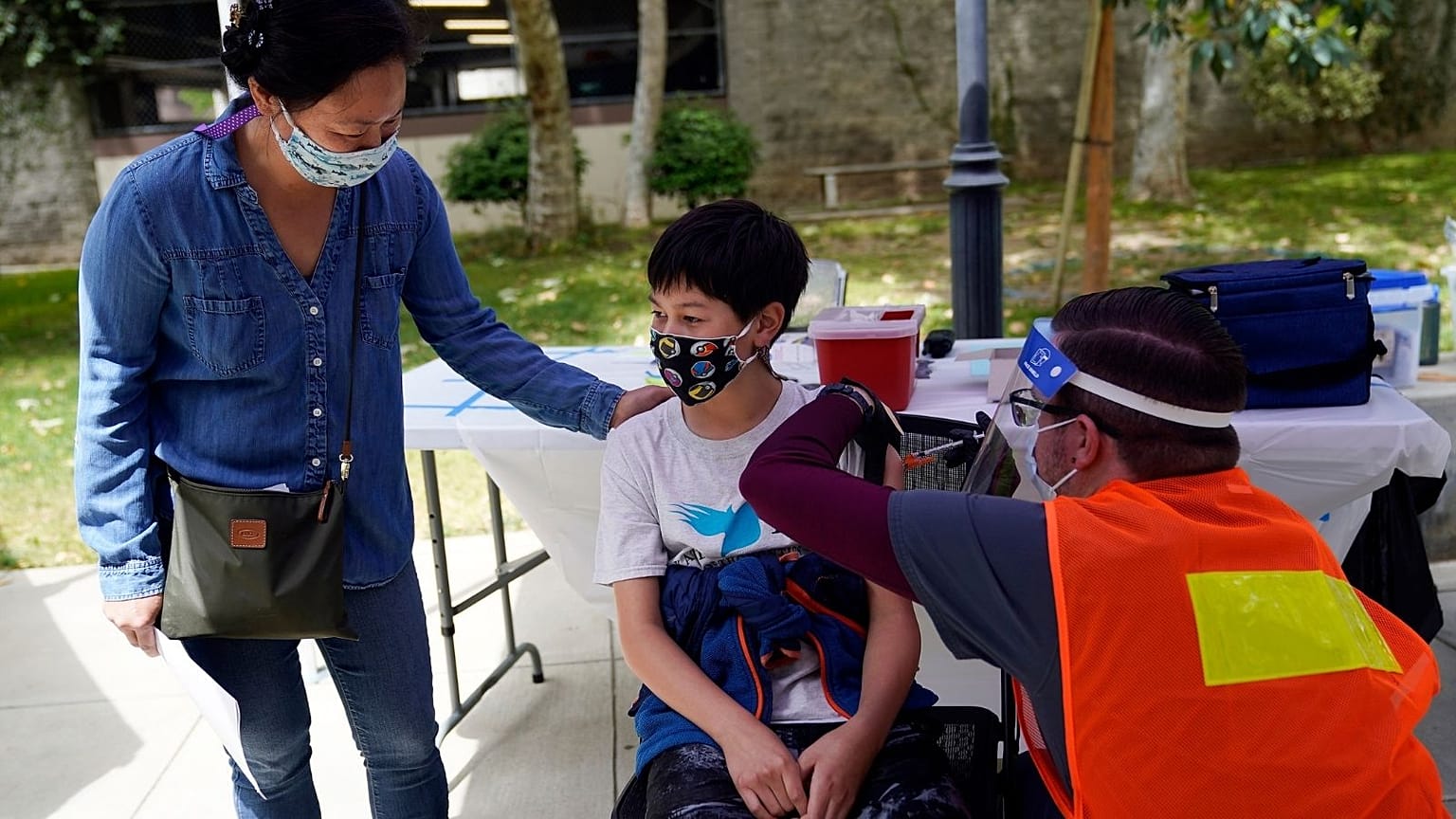 Colin Sweeney, 12, gets a shot of the Pfizer COVID-19 vaccine in California.