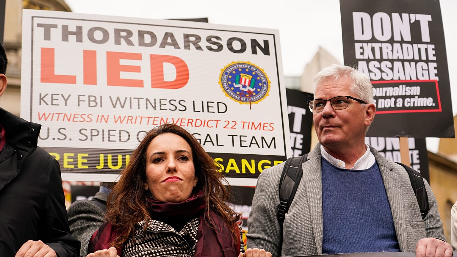 Julian Assange's partner Stella Morris, left, and Wikileaks editor-in-chief Kristin Hrafnsson hold placards and take part in a march in London, Saturday, Oct. 23, 2021
