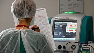 A nurse notes the medical data of a Covid-19 patient at the Pasteur hospital resuscitation unit in Colmar, eastern France, on January 22, 2021.