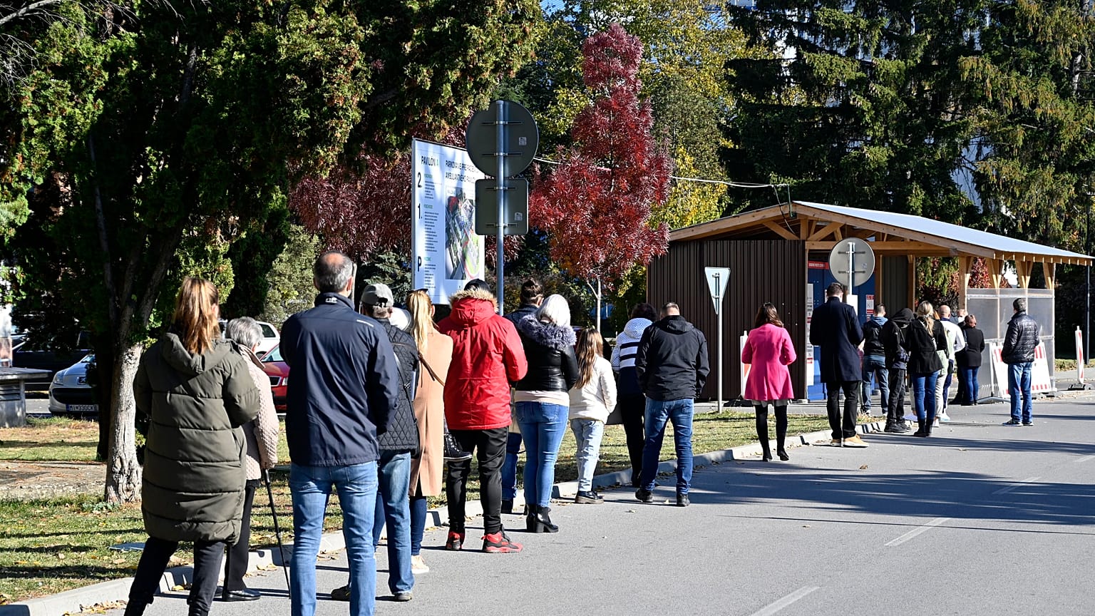 People stand in line to test for COVID-19 in Michalovce, Slovakia, Monday, Oct. 25, 2021. 