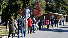 People stand in line to test for COVID-19 in Michalovce, Slovakia, Monday, Oct. 25, 2021. 