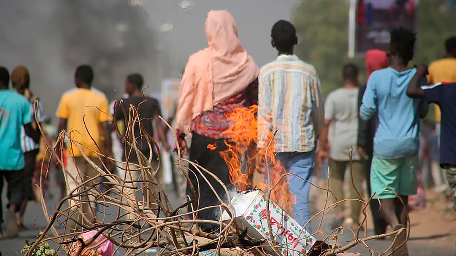 Pro-democracy protesters use fires to block streets to condemn a takeover by military officials in Khartoum, Sudan, Monday Oct. 25, 2021. 