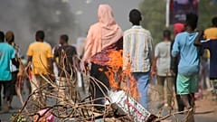 Pro-democracy protesters use fires to block streets to condemn a takeover by military officials in Khartoum, Sudan, Monday Oct. 25, 2021. 