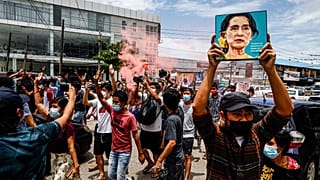 A protester holds up a picture of Myanmar's detained civilian leader Aung San Suu Kyi to mark her birthday during a protest against the military coup, Yangon, June 19, 202`1.