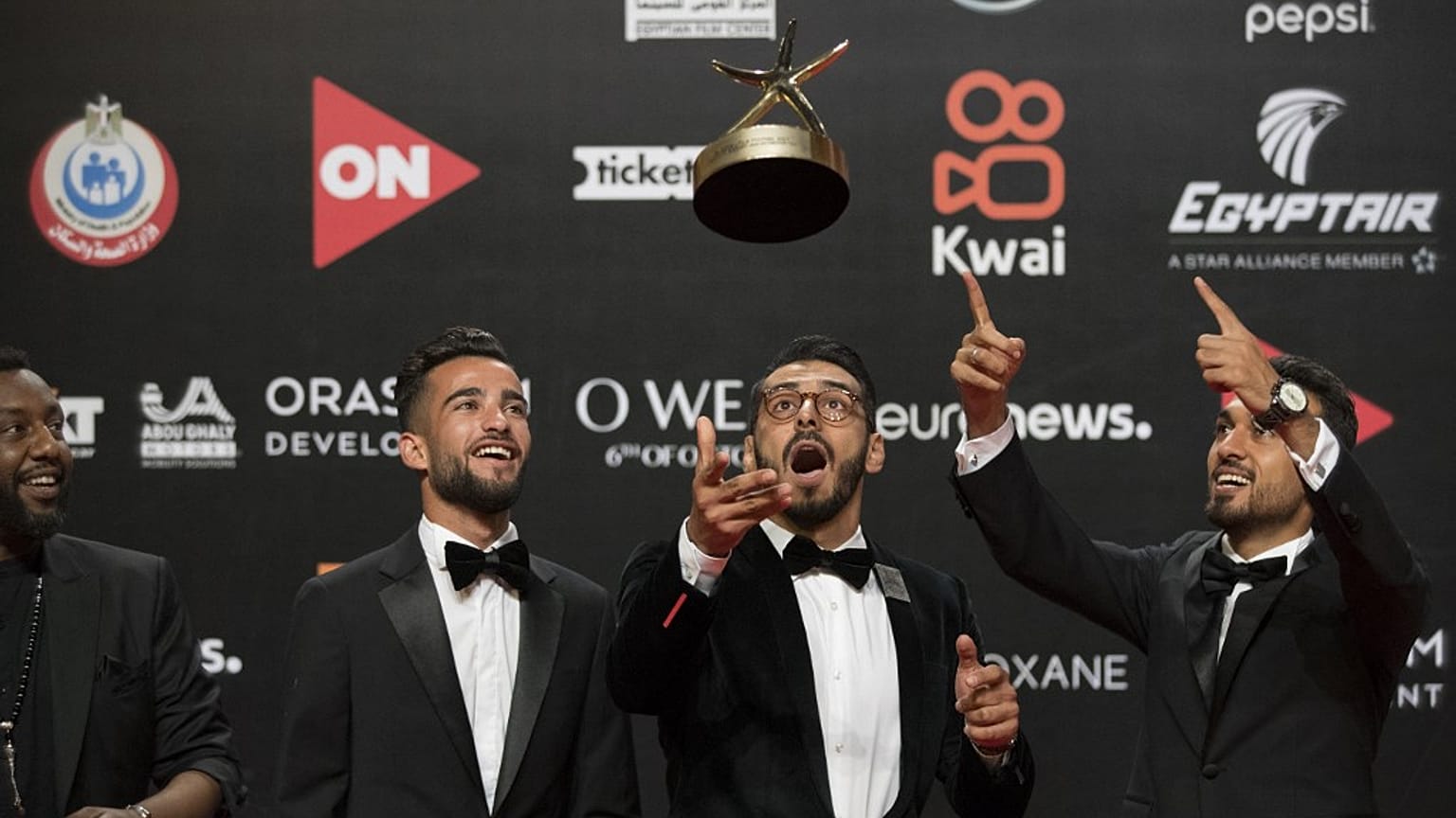 Film director Ali El Arabi (C) poses with his team and their award for the Best Arab Documentary Film during the closing session of the El Gouna Film Festival on October 22.