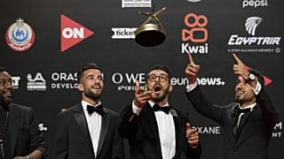 Film director Ali El Arabi (C) poses with his team and their award for the Best Arab Documentary Film during the closing session of the El Gouna Film Festival on October 22.