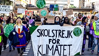 Protesters march during a 'global climate strike' demonstration in Stockholm ahead of COP26 on Friday, October 22
