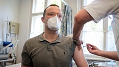 German Health Minister Jens Spahn is vaccinated against influenza in a doctor's office in Berlin, Germany, Wednesday, Oct. 6, 2021.