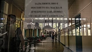 People walk in a corridor at the state hospital in Veliko Tarnovo, Bulgaria, Thursday, Sept. 2, 2021.