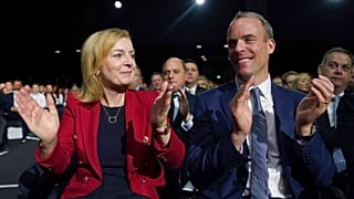 iz Truss, Britain's Foreign Secretary and Dominic Raab, Deputy Prime Minister, applaud as Britain's Prime Minister Boris Johnson makes a speech.