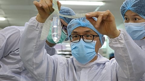 Founder and inventor of Wondaleaf Unisex Condom John Tang Ing Ching inspects the unisex condom at his factory in Sibu, Malaysia October 19, 2021.