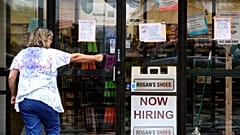 A hiring sign is displayed outside a retail store in Buffalo Grove, Illinois, US, June 24, 2021. 