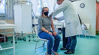 A woman receives a COVID vaccine in Saint Margit Hospital in Budapest.