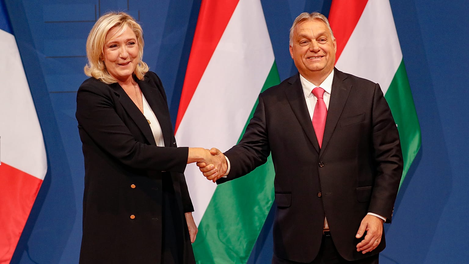 French far-right leader Marine le Pen, left, shakes hands with Hungarian Prime Minister Viktor Orban after a joint press conference in Budapest, Hungary, 26 October 2021.
