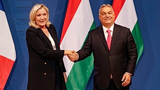 French far-right leader Marine le Pen, left, shakes hands with Hungarian Prime Minister Viktor Orban after a joint press conference in Budapest, Hungary, 26 October 2021.