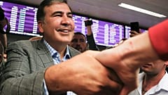 Georgia's former President Mikheil Saakashvili greets supporters upon arrival at Boryspil Airport, outside Kyiv, Ukraine, May 29, 2019.