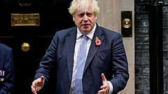 Britain's Prime Minister Boris Johnson meets with fundraisers for the Royal British Legion and purchases a poppy in front of 10 Downing in London, Friday, Oct. 29, 2021.